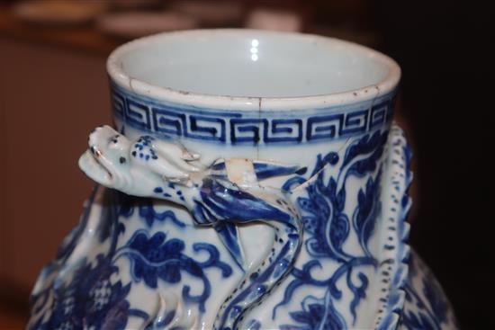 A pair of 19th century Chinese blue and white vases with applied dragons to the neck, wood stands and a white glazed vase (5) tallest 3